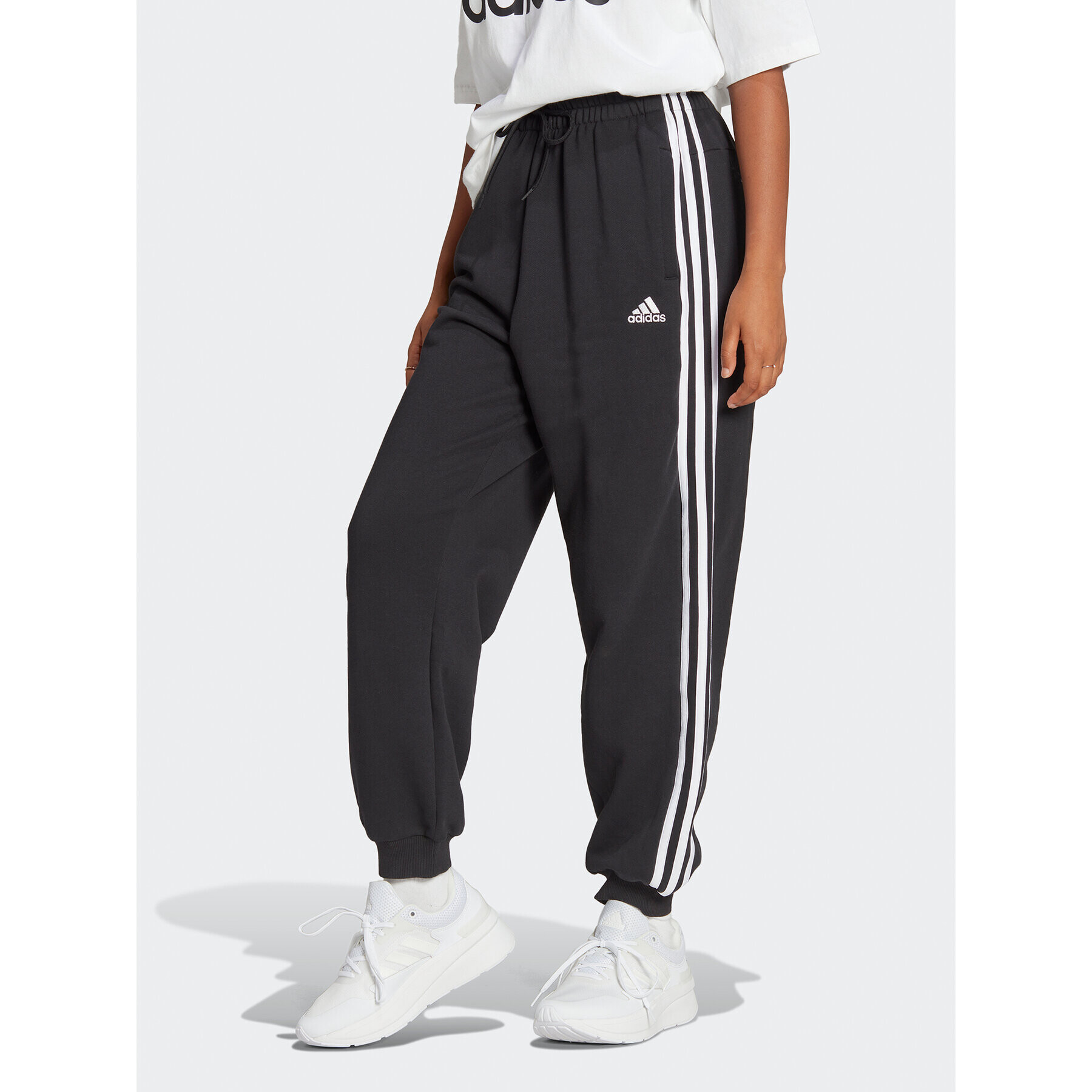 adidas Melegítő alsó Essentials 3-Stripes French Terry Loose-Fit Joggers HA4375 Fekete Loose Fit - Pepit.hu